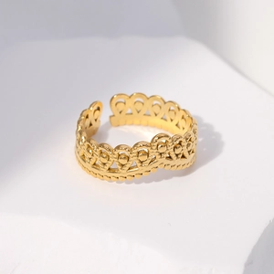 Detailed view of adjustable golden crown ring with intricate hollow wave pattern