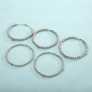 Detail of five different bead sizes of stainless steel ball chains with lobster clasps
