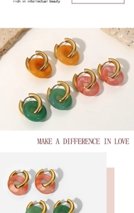 Detailed view of resin hoop earrings in orange, pink, and green with 18K gold plating
