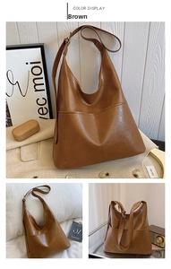 Close-up of vintage brown PU leather tote bag showing fine texture and front pocket detail