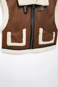 Detail of brown faux suede vest with cream shearling collar and zipper closure