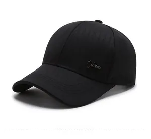 Close-up of black cotton baseball cap showing detailed metal letter logo and stitching