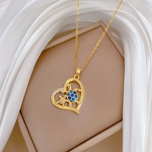 Golden heart necklace detail with blue turtles and I love you mom engraving