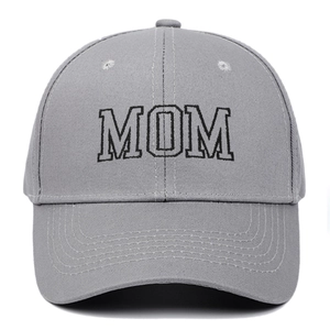 Close-up of grey cotton baseball cap featuring black embroidered MOM text and curved brim