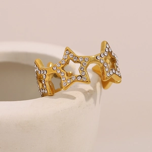 Macro detail of 18K gold plated star open ring with sparkling white zircon stones