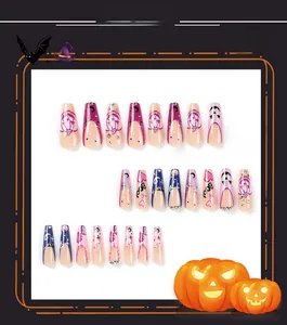 Detailed macro view of Halloween press-on nails featuring purple glitter and ghost art