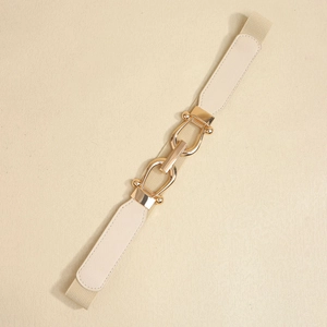 Close-up of interlocking gold buckle on cream elastic waist belt for women's dresses