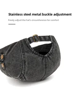 Detail of vintage washed cotton flat cap featuring an adjustable stainless steel metal buckle