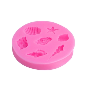 Pink silicone fondant mold featuring starfish and seashell shapes for cake decorating
