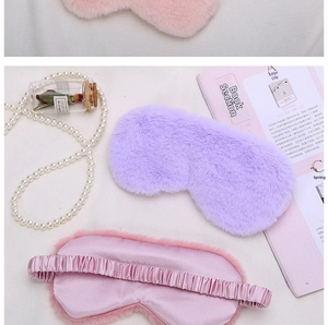 Detail of plush sleep masks in purple and pink with satin back and elastic straps