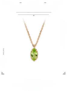 Detailed macro view of Marquise-cut olive green stone on a 14K gold plated silver necklace