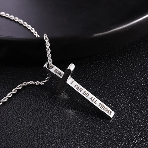 Detailed macro view of silver cross pendant with Philippians bible verse engraving