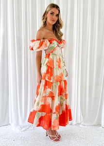 Detail of floral print maxi dress featuring off-shoulder puff sleeves and tiered skirt