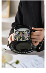 Macro detail of Van Gogh iris floral art on a ceramic coffee cup and saucer set
