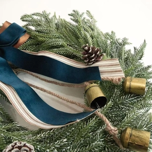 Christmas wreath with navy velvet bows, vintage metal bells and pine needles for front door