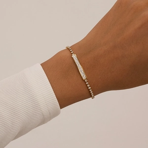 Close-up of gold stainless steel tennis bracelet with micro-pave zircon rectangular bar