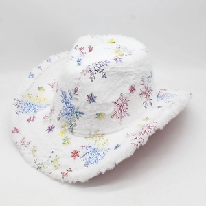 Close-up of white velvet cowboy hat with colorful snowflake patterns and faux fur trim