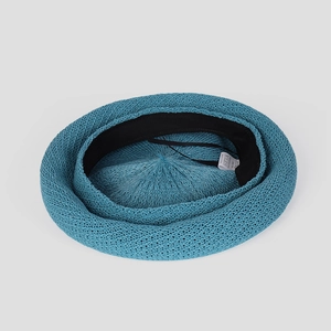 Detail of blue knitted beret showing breathable texture and adjustable inner drawstring