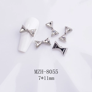 Detailed view of silver bow-shaped nail art charms with K9 triangle crystals in 7x11mm