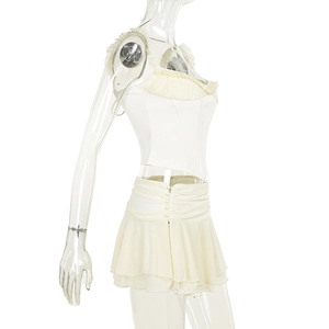 Detail of the white ruffled bustier top and layered mini skirt set on a clear mannequin