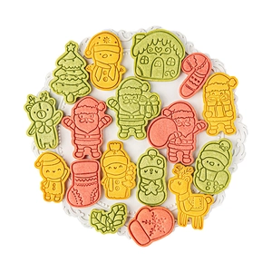 16pcs Christmas cookie cutters featuring Santa Claus, Snowman, and Reindeer shapes on a white tray