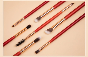 Detail of 8-piece professional eye makeup brush set with red handles and gold ferrule