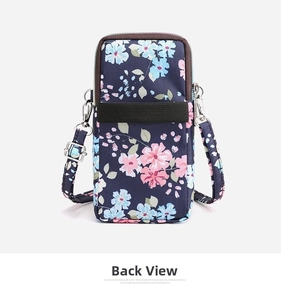 Rear view detail of floral nylon mini shoulder bag with brown zipper and elastic strap