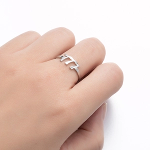 Macro detail of silver stainless steel ring featuring 777 lucky number cutout design