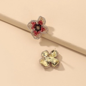 Detailed view of vintage crystal flower earrings with purple beads and golden petals