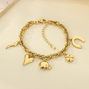 Detailed shot of 18K gold plated bracelet with elephant, heart and clover charms