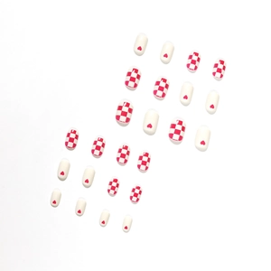 Creamy white and red press-on nails with heart patterns and checkered designs