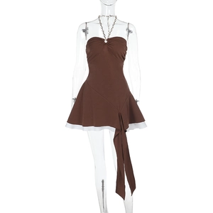 Detail of halter chain neckline and asymmetric pleats on brown backless dress