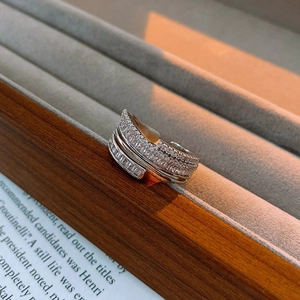 Macro shot of multi-layer silver ring with sparkling white zircon stones and sleek design