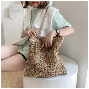 Detail view of the hollow diamond weave pattern on this tan woven shoulder bag
