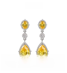 Detail of drop-shaped yellow zircon earrings with sparkling micro-pave setting and silver base