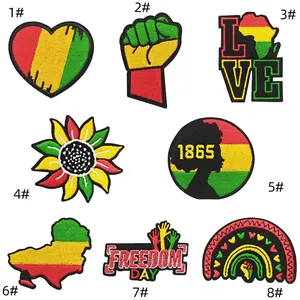Close-up of 8 colorful Pan-African embroidered patches with heart and power fist motifs
