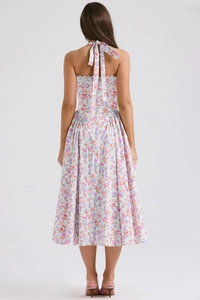 Detail of the back view showing the halter tie-up bow on a floral midi dress