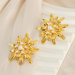French vintage gold flower earrings with pearls on white silk background