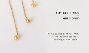 Detailed macro view of 18K gold plated chain earrings with polished solid bead accents