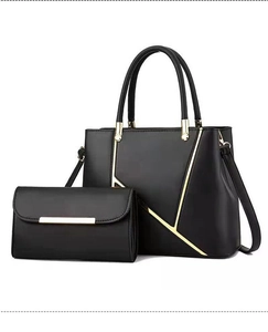 Close-up of black leather tote bag set with golden hardware and matching long wallet