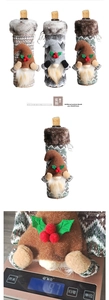 Detail of Christmas gnome wine bottle cover showing knitted texture and 9.7g weight