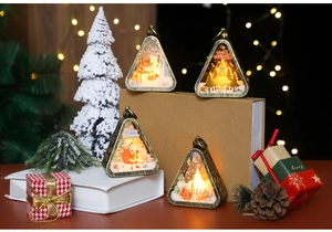 Close-up of vintage bronze Christmas lanterns with warm lights and festive scenes