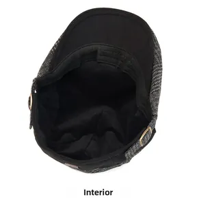 Detail of the warm black fleece lining and internal texture of the herringbone flat cap