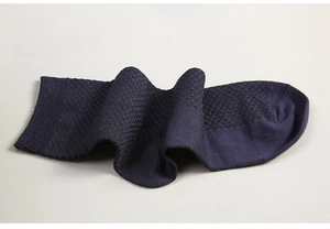 Close-up of navy blue bamboo fiber socks showing breathable mesh knit and elastic rib cuff