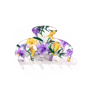 Detail of floral printed acrylic hair claw clip with purple and yellow flower patterns