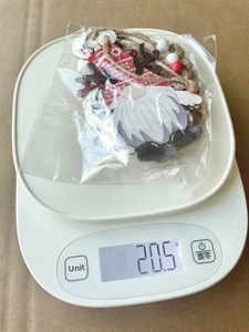 Detailed weight measurement of a wooden Christmas gnome ornament showing 20.5g on a scale