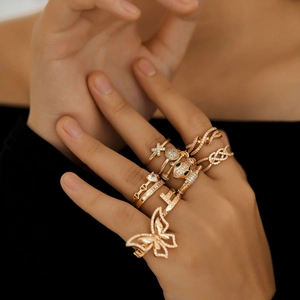 Close-up of gold rings with micro-set zircon butterfly, heart, and cross patterns