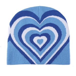 Detailed knit texture of a blue and white heart pattern beanie hat for winter