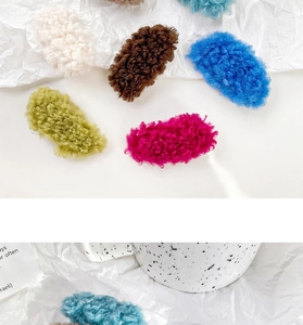 Flat lay of colorful lamb wool oval hair clips in white, brown, blue, green and pink