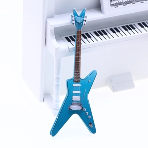 Macro detail of a miniature blue electric guitar model for dollhouse scene decoration